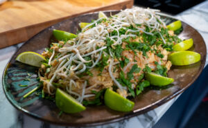 Big Platter of Shrimp Pad Thai, garnished with lime wedges and beansprouts